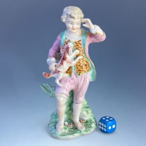 C18th Derby Porcelain Figure of a Boy Holding a Puppy.