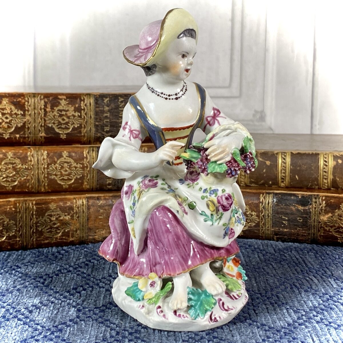 Bow Figure of a Girl Holding a Basket of Grapes.