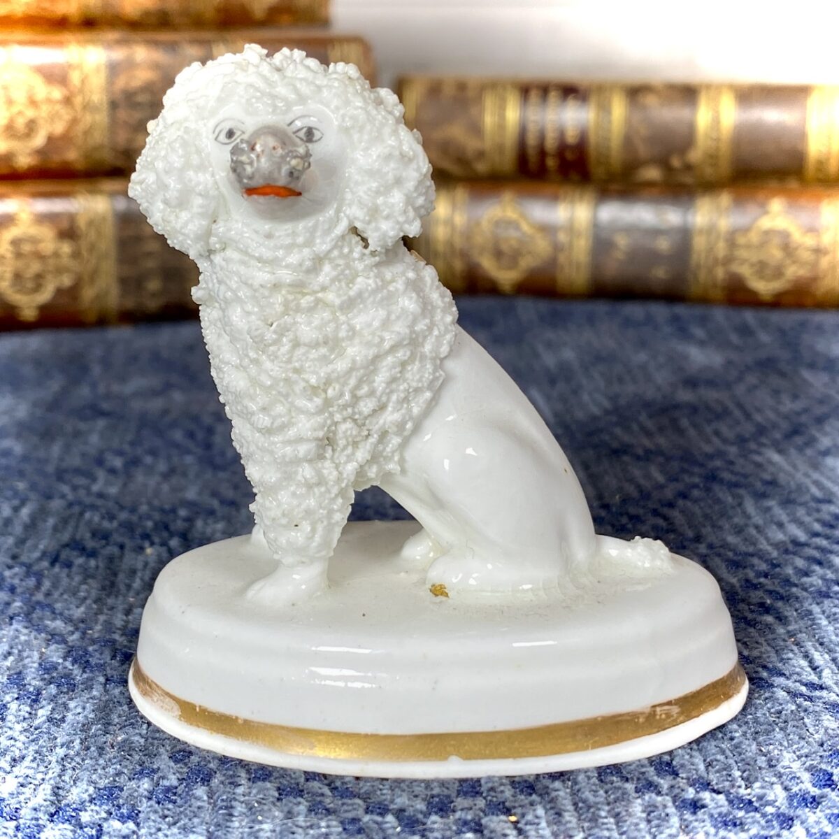 Staffordshire Porcelain Seated Poodle on an Oval Base
