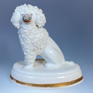 Staffordshire Porcelain Seated Poodle on an Oval Base