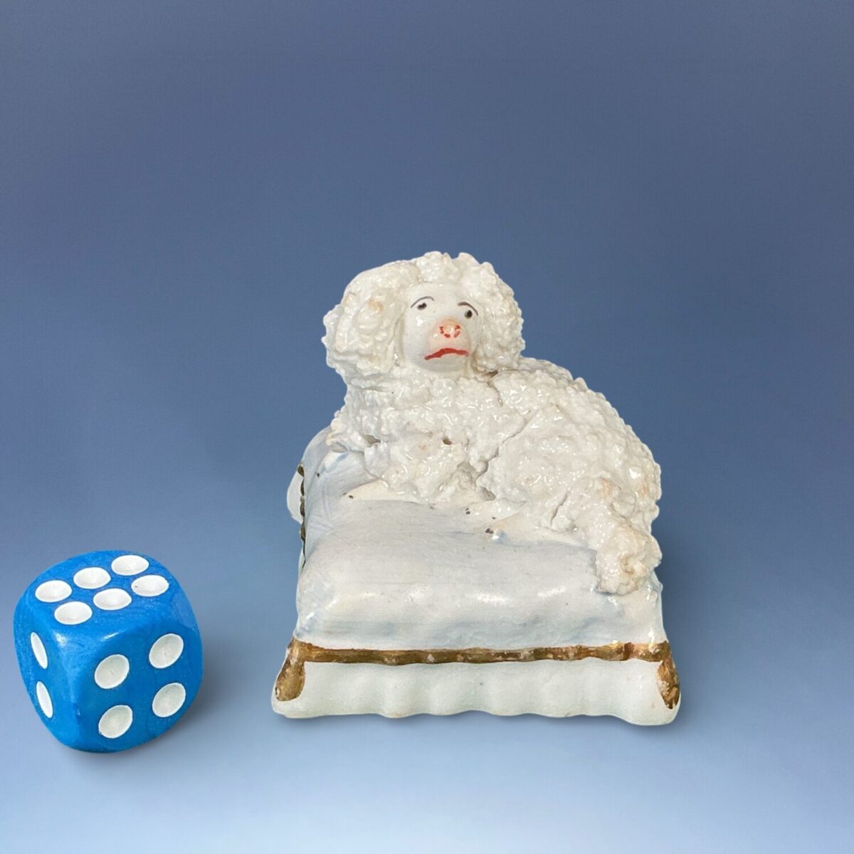 C19th Staffordshire Porcelain Small Poodle on Cushion.