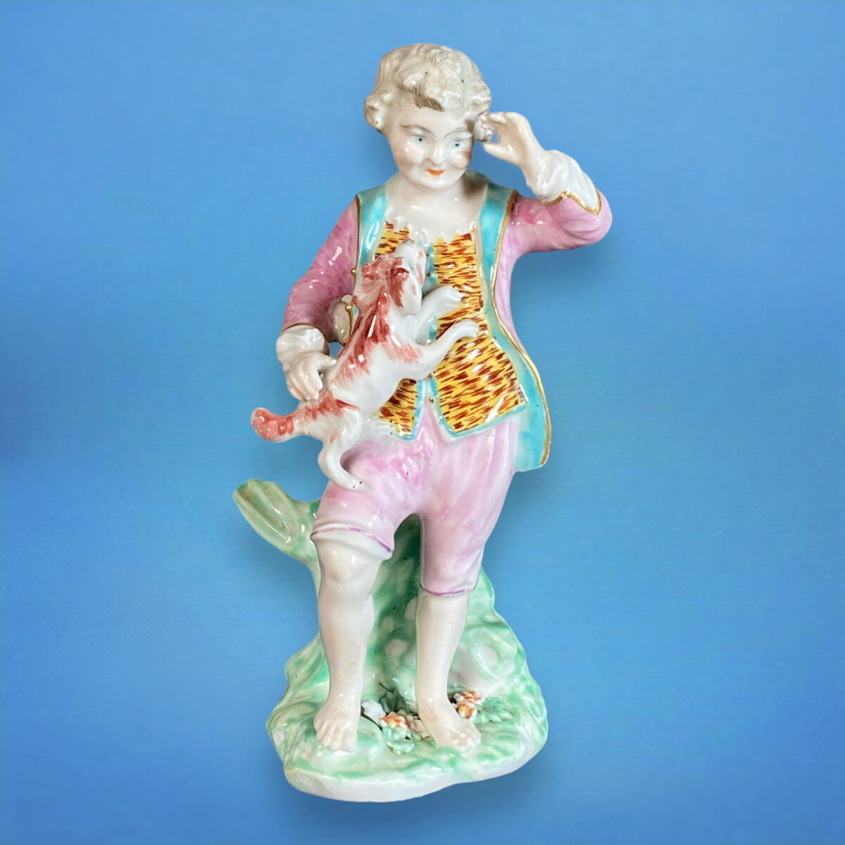 C18th Derby Porcelain Figure of a Boy Holding a Puppy.