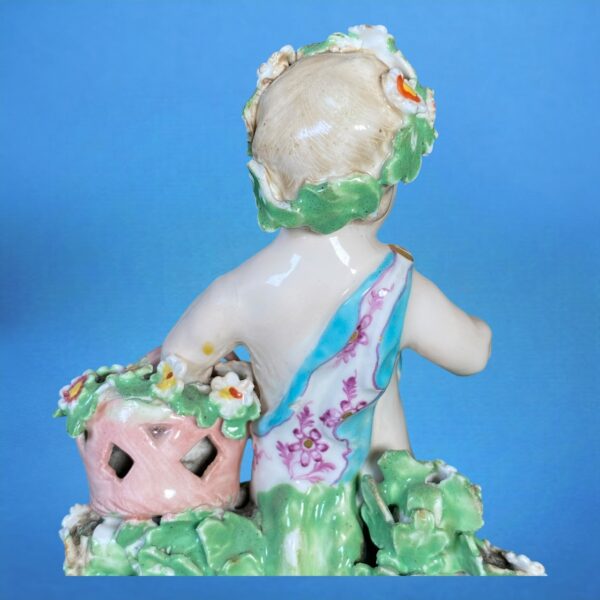 (Clearance) Chelsea-Derby Figure of a Putto With Basket of Flowers. - Image 3