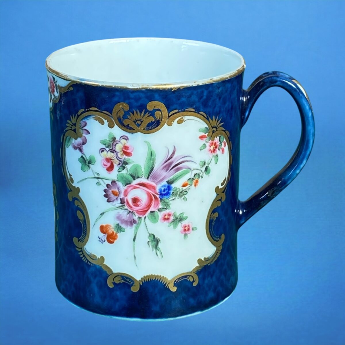 1st Period Worcester Porcelain Scale Blue Mug with Floral Panels.