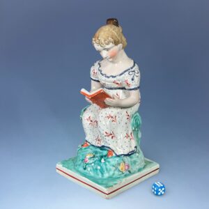 Early Staffordshire Pottery Figure of a Girl Reading. (RESERVED)