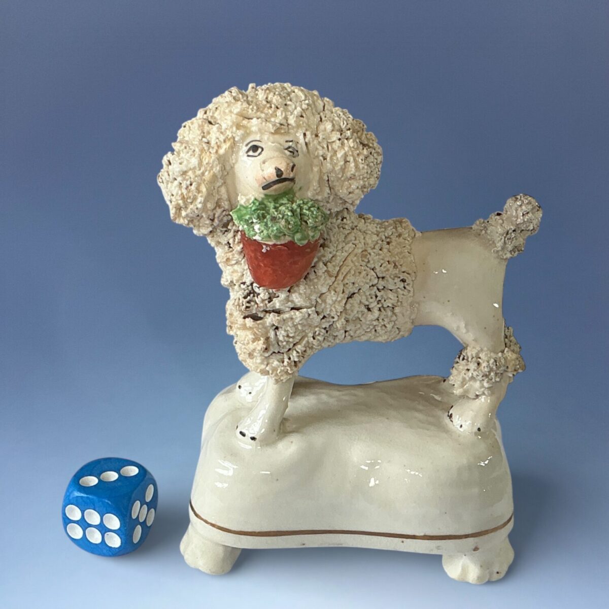 Staffordshire Porcelain Poodle Carrying a Basket of Flowers.
