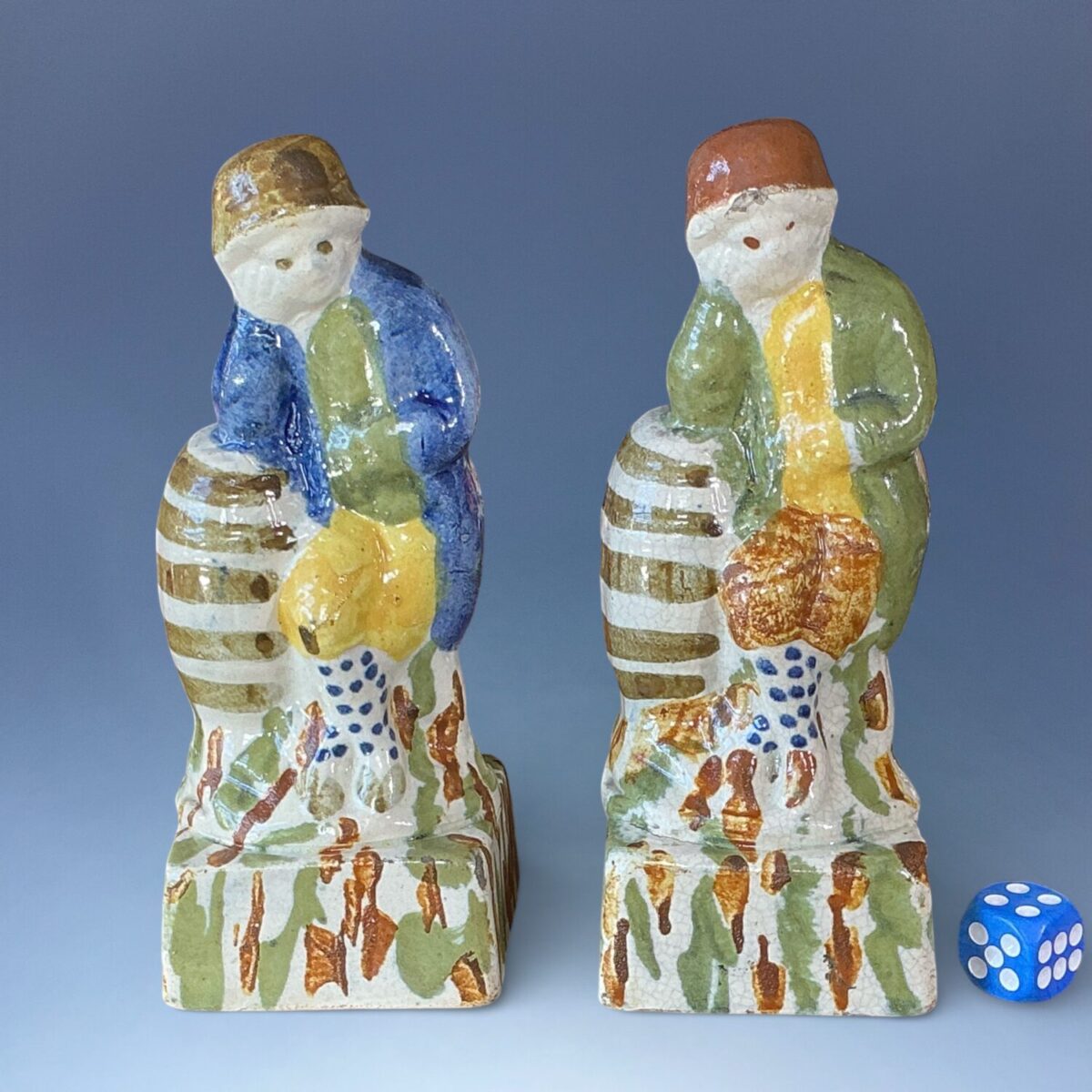 Pair of Early Staffordshire – Pratt Ware Figures of Boys Leaning on Barrels