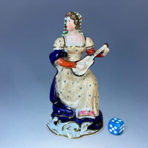 Staffordshire Porcelain Figure of a Female Guitar Player.